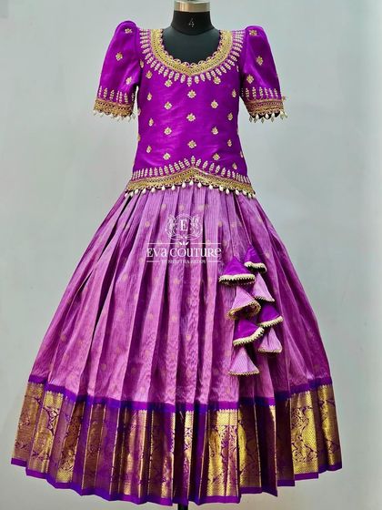 A regal all-purple Kanchi Pattu lehenga. The blouse is beautifully embroidered, and the skirt has a rich gold border.