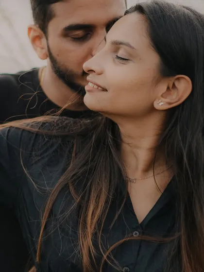 An intimate close-up that captures a tender moment. The focus on their faces and the soft light create a very personal and emotional portrait.