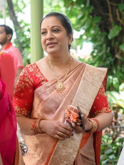 A candid moment of Chandrakala at her daughter's wedding, looking elegant and poised.