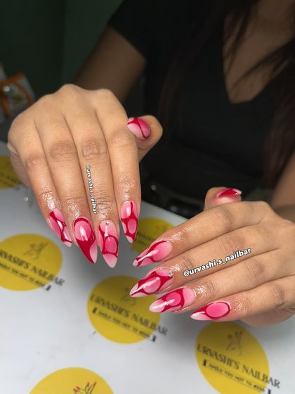 Bold and confident, this abstract design uses sharp lines and soft curves in shades of pink and red. The glossy, artistic swirls create a statement look that's impossible to ignore.