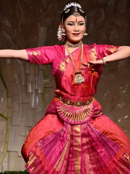 The vibrant colors of the costume and the confident smile of the dancer capture the celebratory spirit of an arangetram. Stuti Mukherjee presents her art with poise and joy.