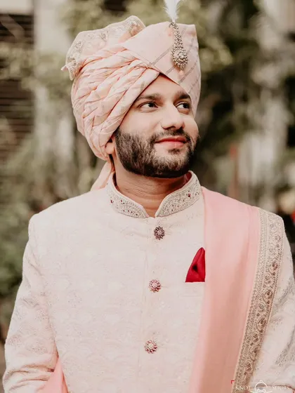 A close-up portrait of the groom, capturing his happy and relaxed expression. He looks every bit the handsome and ready groom.