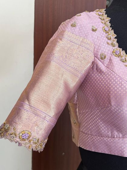 A hand-embroidered pastel beauty. This lilac Kanjeevaram blouse features delicate floral embroidery with hints of purple threadwork on the sleeves and neckline.