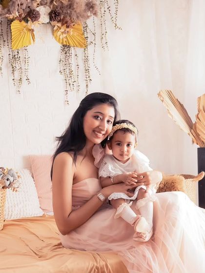 A classic portrait of mother and child. Her loving gaze and the baby's sweet expression make this a photo to be treasured for years to come.