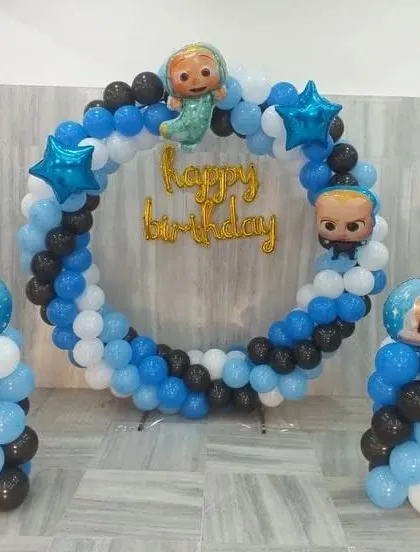 A simple and sweet Boss Baby and Cocomelon circular balloon arch, perfect for smaller spaces or home celebrations.