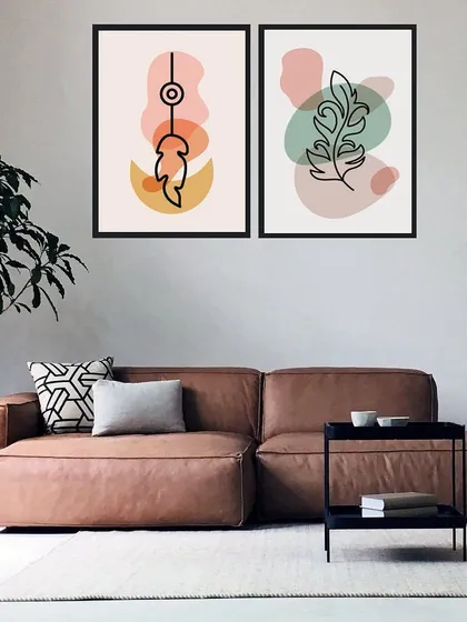 This set of two framed prints features abstract leaf drawings against soft, pastel-colored shapes. The delicate lines and gentle colors create a calm and artistic atmosphere.