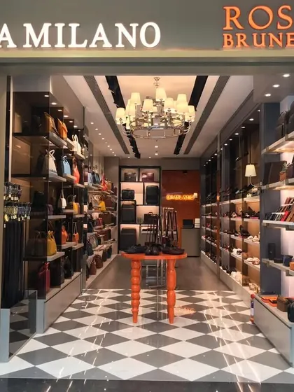 The entrance to the combined Da Milano and Rosso Brunello store in Hyderabad. We designed a unified storefront that gives each brand its own identity while creating a cohesive and powerful retail presence, featuring a classic checkerboard floor and a dramatic chandelier.