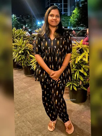 Another happy client looking elegant in my black handloom Ikat peplum top and pants set. The V-neck and flared top create a flattering silhouette.