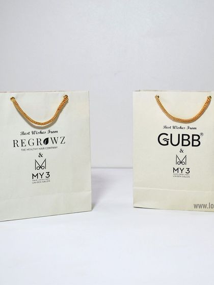 We can create custom paper bags for multiple brands, as shown here with bags for Regrowz and Gubb. Consistent quality and design ensure a professional presentation for any event.
