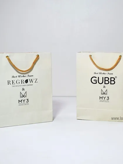 We can create custom paper bags for multiple brands, as shown here with bags for Regrowz and Gubb. Consistent quality and design ensure a professional presentation for any event.