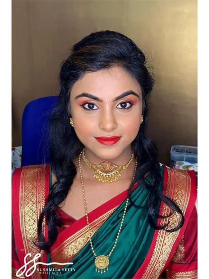 This is a perfect look for a wedding guest. I used warm, shimmery eyeshadows and a bold red lip to complement her beautiful green and red saree, making her stand out elegantly.
