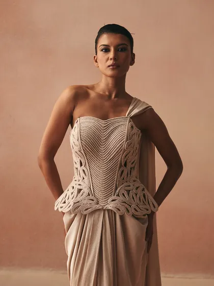 A frontal view of the Karov gown, highlighting the heart-shaped neckline of the corded corset and its peplum detail, which reimagines classic forms for modern Indo-Western occasions.