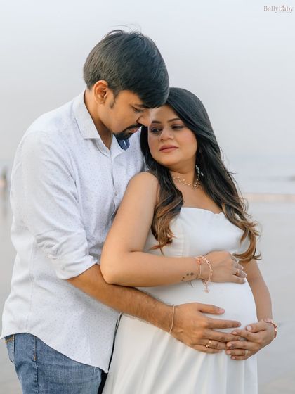 A quiet, heartfelt moment on the beach as they wait for their baby. The ocean breeze and soft light make for such romantic couple portraits.