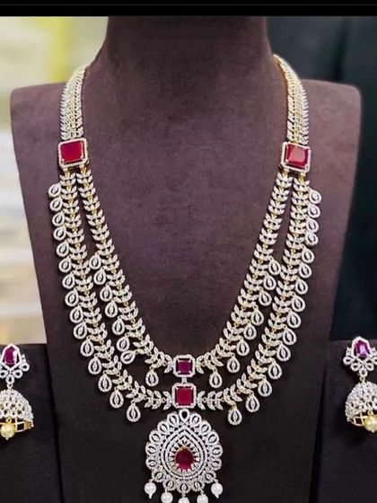 The same layered necklace design is also available with red stones. This is a versatile piece that can be rented for various occasions, from parties to family functions.