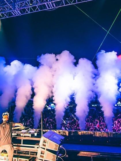 A side view of the stage, capturing the cryo effects and the sheer size of the crowd.