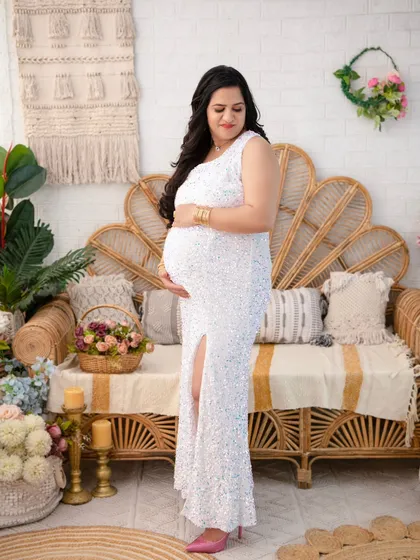 This full-length portrait showcases the elegance of a one-shoulder sequin gown against our textured boho backdrop. It's a beautiful composition that captures the mother's grace and the anticipation of the new arrival.