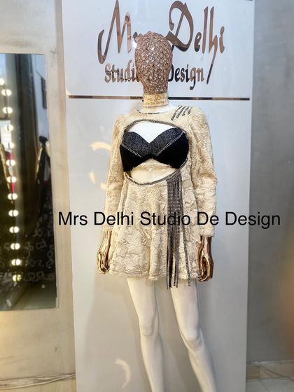 A unique customized winter dress. This piece features a cream-colored fur-like texture with a bold black bralette cutout, perfect for making a fashion statement.