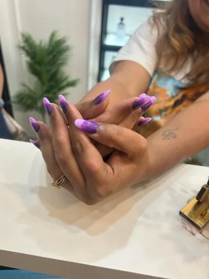 Here you can see how the purple ombre nail extensions look from a different angle. The length and shape make a dramatic statement, while the color blend keeps it sophisticated.