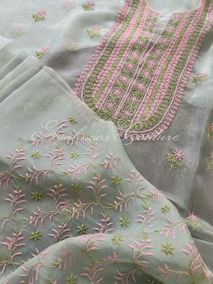 A flat-lay of the suit, showing the jaal pattern on the sleeves and the 'bel' and 'booti' design on the dupatta.