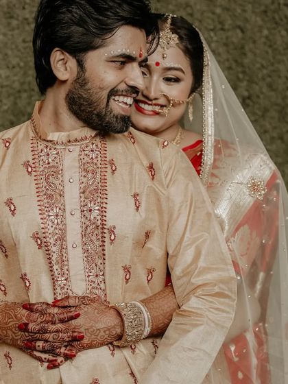 A candid, happy portrait of a couple during their Bengali wedding ceremony, their smiles radiating pure joy.