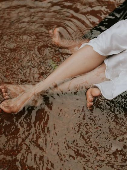 An abstract and artistic shot of a couple's feet in the rippling water. I love finding these unique perspectives during a creative couple session.