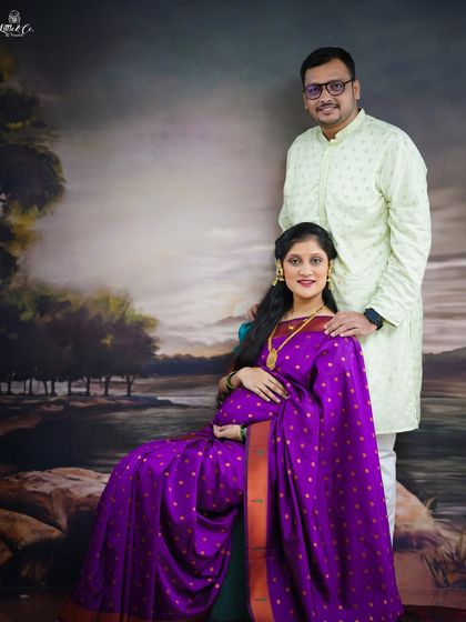 A classic seated portrait of the couple in their ethnic wear. This pose is elegant and formal, perfectly capturing the grace of this special time in a traditional setting.