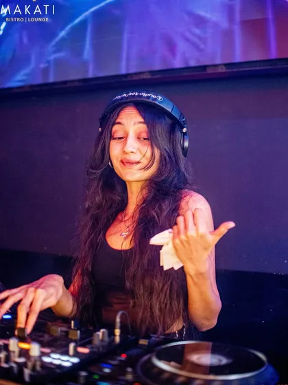 Wiping my brow but still in the zone. DJing is a workout, but I wouldn't have it any other way. The energy exchange with the crowd is everything.