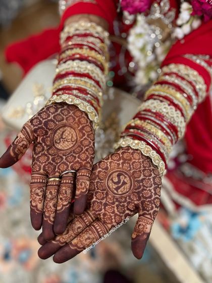 The rich stain on an engagement mehndi with custom initials.