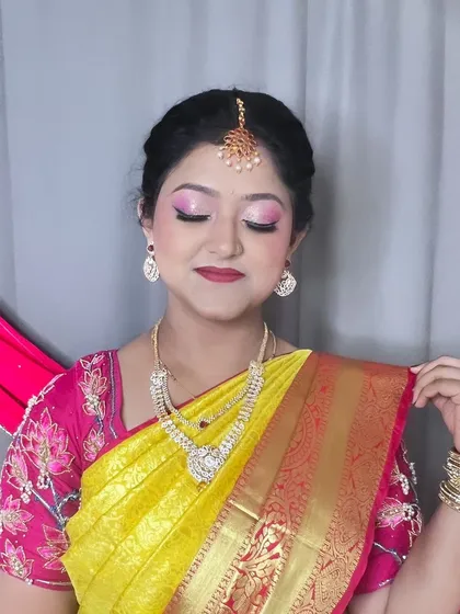 A close-up of the eye makeup for this festive look. I used shades of pink and a touch of shimmer to match her vibrant yellow Kanjivaram saree.
