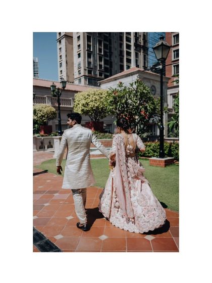 The couple walking away hand-in-hand, a classic "happily ever after" shot.