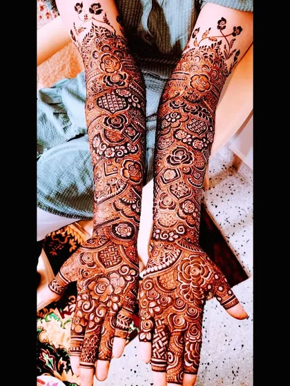 The complete bridal mehndi for Farheen, showing the detailed work on her hands and feet, and the beautiful final stain.