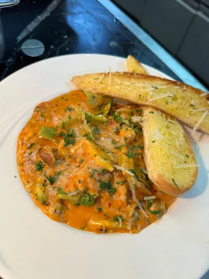 Food is art. A close-up of a delicious pasta dish from my collaboration with Crowne Plaza, focusing on the presentation and quality of the food.