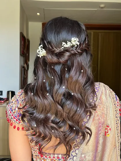 This hairstyle is a perfect blend of elegance and simplicity, ideal for a daytime Haldi ceremony.