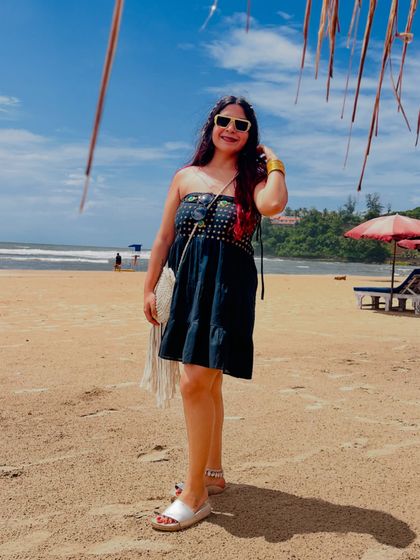 A sunny day at the beach in Goa. I'm wearing a comfortable strapless dress with a macrame sling bag, a perfect casual beach day look.