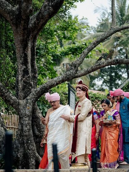 The groom's procession makes its way towards the ceremony area, a vibrant and traditional scene.