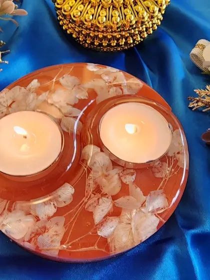 An orange and white floral tealight holder, another beautiful option for your festive decor.