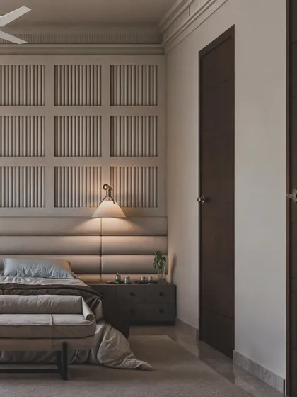 This view highlights the gridded, paneled wall behind the bed, adding a classic architectural detail to the modern space.