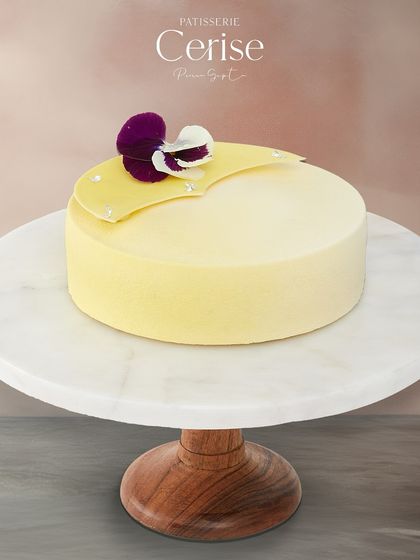 A full view of L’Exotique, a dessert that transports you to a fruity paradise with its blend of tropical fruits and white chocolate.