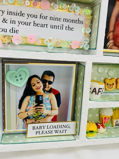 "Baby loading, please wait." A fun and modern touch to this baby shower frame, capturing the couple's excitement.
