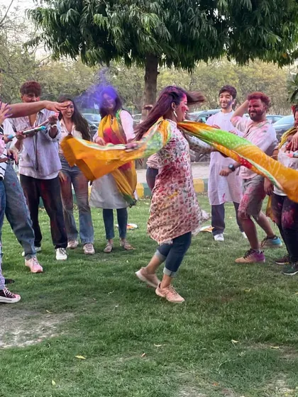 A candid moment of our students playing with colors and dancing in a circle. This is the true spirit of Holi.