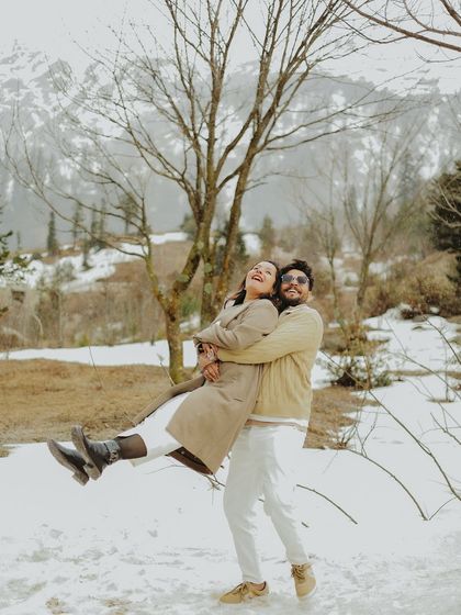 Pure, unadulterated joy in this playful lift during a post-wedding shoot in the snow.