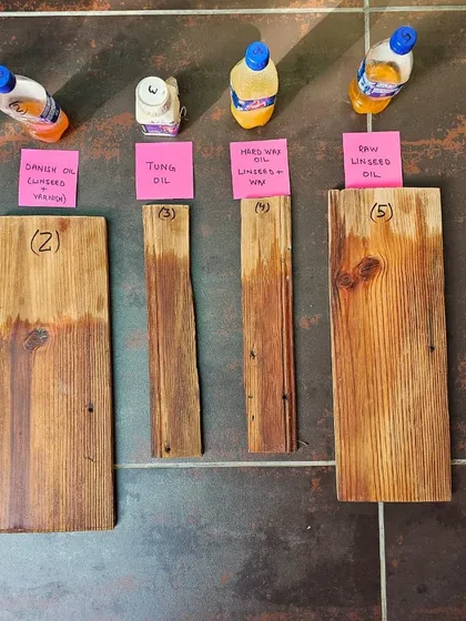 Testing different wood finishes is a crucial part of the restoration process. These samples show various oils and waxes being tested on reclaimed wood, a detail from our hands-on work at The Verdun House.