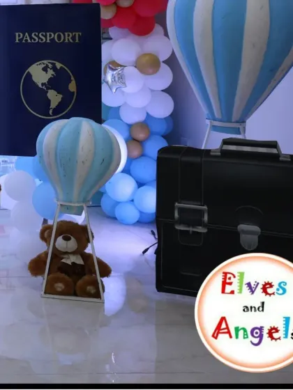 A close-up of the charming details, including the mini hot air balloon and vintage-style luggage.