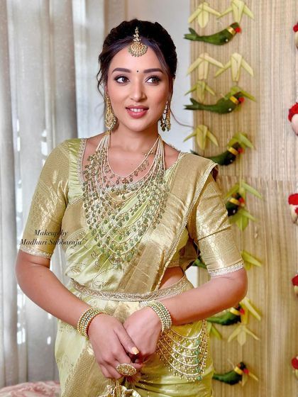 A candid shot capturing the client's elegance and the shimmer of her silk saree.