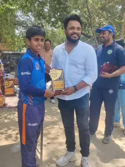A smile of achievement. This player is receiving his well-deserved award for his contribution to the team's success.
