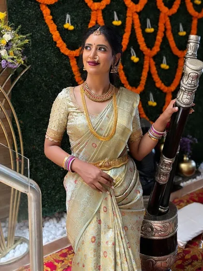 A beautiful pastel green Kanchivaram saree with a matching gold-embroidered blouse. A perfect choice for a daytime wedding or event.