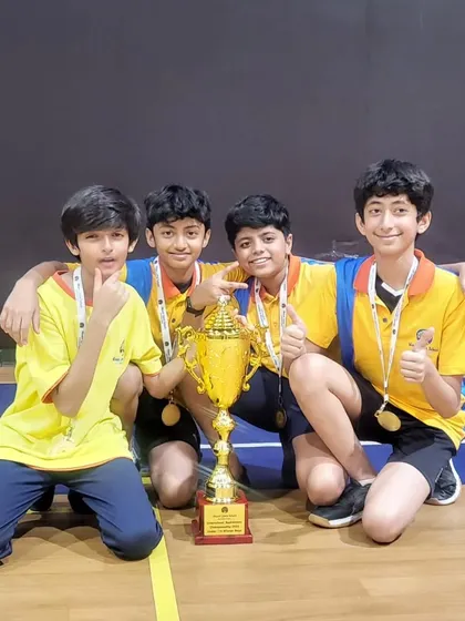 The victorious U-12 boys doubles team celebrating their win at the Mount Litera School International inter-school tournament.