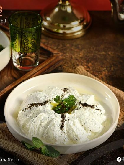 Our Labneh with Garlic and Mint is a refreshing and creamy yogurt dip. The coolness of the mint and the subtle bite of garlic make it a perfect accompaniment to our fresh pita bread.