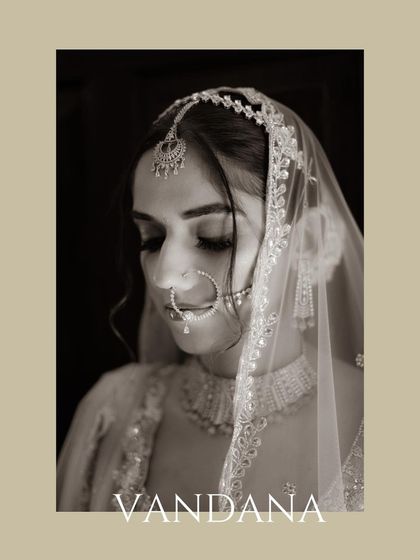 A timeless black and white close-up of the bride, her eyes gently closed, highlighting her delicate jewelry.