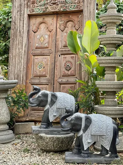 Welcome good fortune with a pair of grand elephants at your entrance. In our culture, an 'Anney' or elephant with its trunk up is an auspicious symbol. This pair is handcrafted from black granite with contrasting grey details to create an impressive welcome.